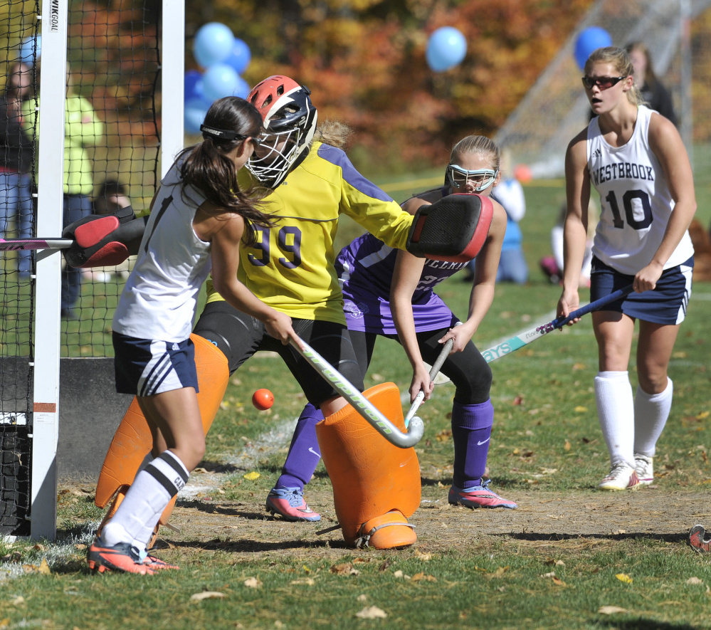Deering goalie Lillian Frager stops a scoring bid by Westbrook’s Abby St. Clair in the second half of a Class A South field hockey prelim Saturday. Westbrook advanced with a 1-0 victory.