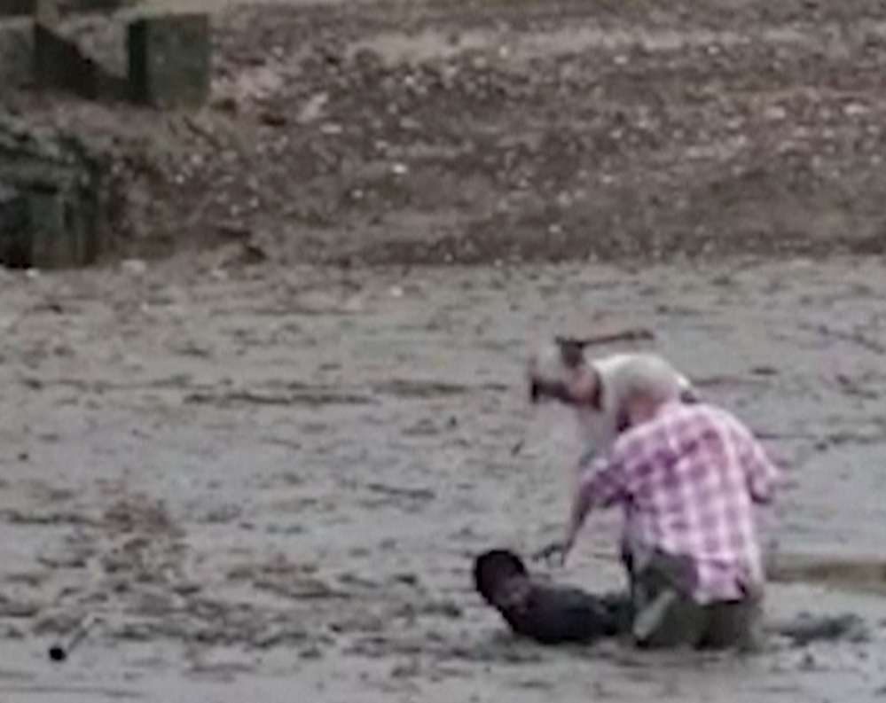 Thai construction worker Chat Ubonchinda lies in the mud to help two Norwegian bird watchers who were sinking.