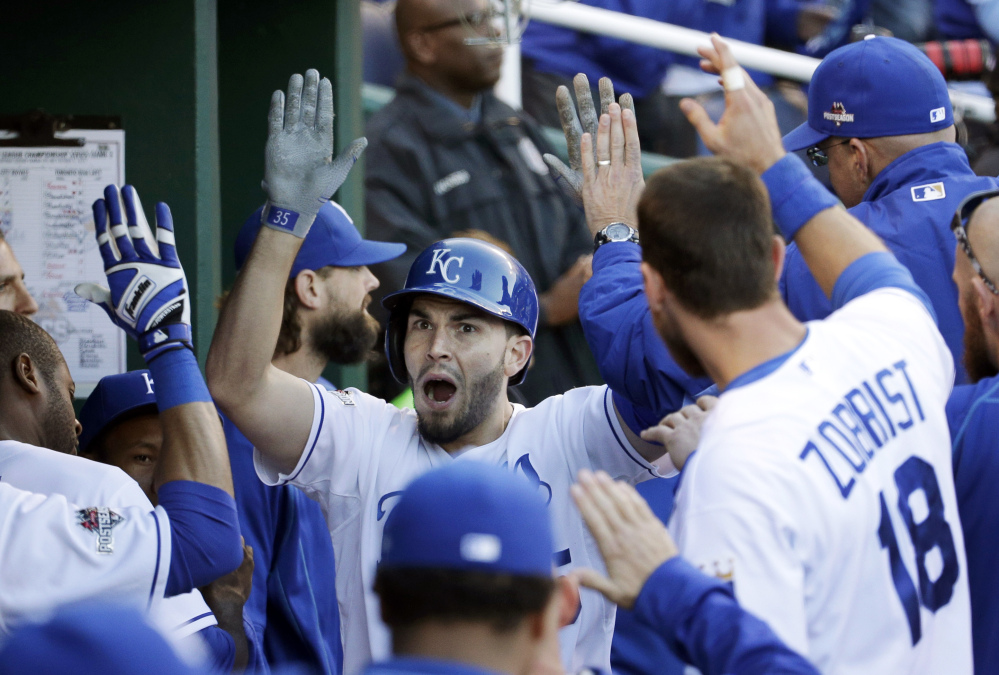 Royals first baseman Eric Hosmer celebrates in the dugout with teammates Saturday after scoring on a single by Mike Moustakas in the seventh inning of Game 2 of the American League Championship Series.