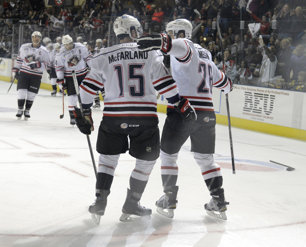 John McFarland of the Portland Pirates congratulates teammate Wade Megan following Megan’s go-ahead goal on a backhander in the second period at the Cross Insurance Arena.