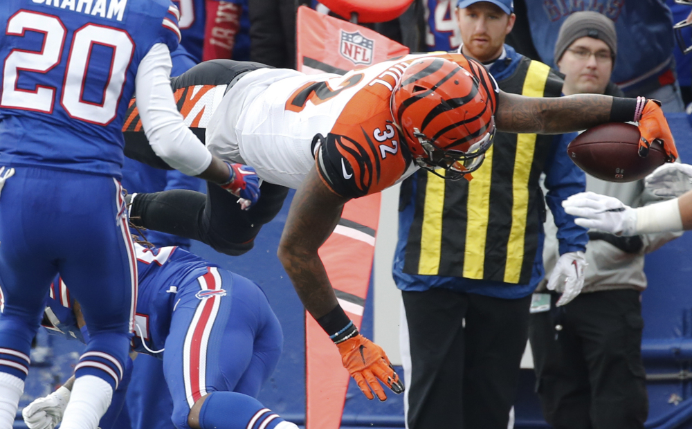 Bengals running back Jeremy Hill dives into the end zone for a touchdown Sunday against the Buffalo Bills. Cincinnati improved to 6-0 with a 34-21 victory.