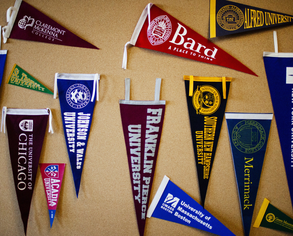 College pennants hang on a bulletin board at the guidance office at Portland High School.