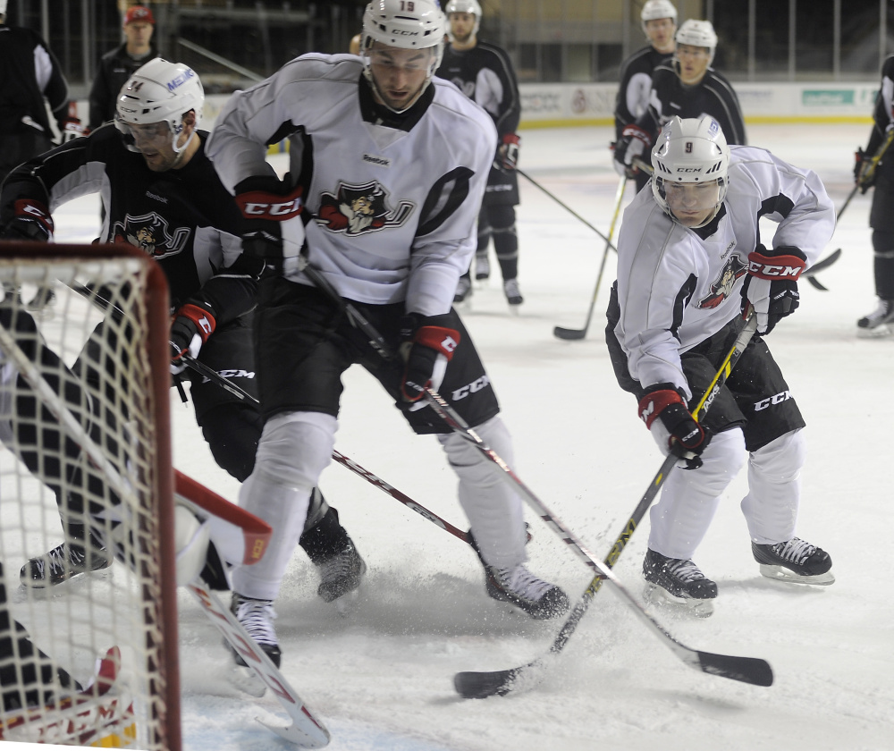 Rocco Grimaldi, right, is the Pirates shortest player at 5-foot-6. The second-year pro feels his lower center of gravity works to his advantage.practice. (Photo by Gordon Chibroski/Staff Photographer)