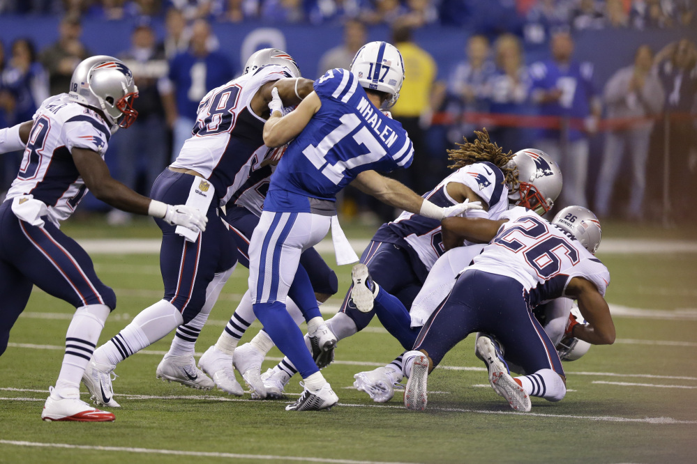 Colts wide receiver Griff Whalen, 17, watches as teammate Colt Anderson is tackled by New England’s Brandon Bolden and Logan Ryan on a botched fake punt from Colts 37-yard line in the third quarter of the Patriots’ 34-27 win Sunday in Indianapolis.