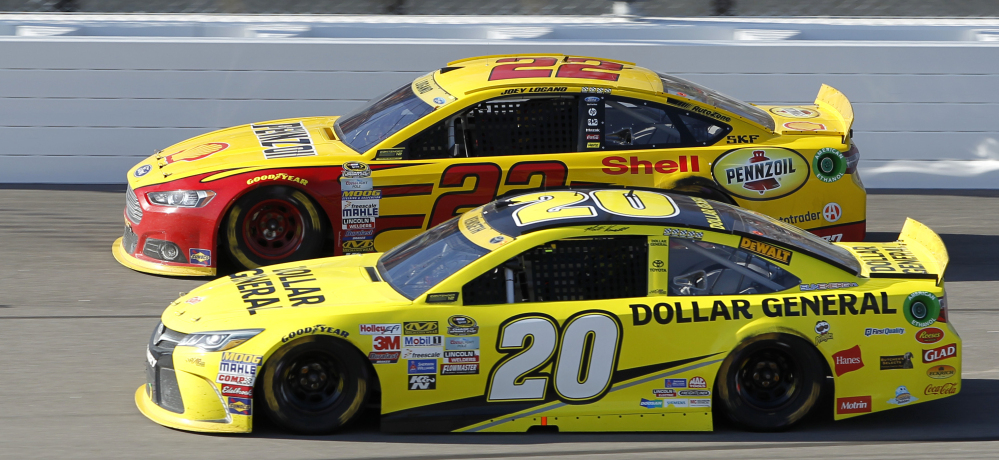 Joey Logano, top, and Matt Kenseth run side-by-side at the Kansas Speedway on Sunday, in a race won by Logano in the closing laps after his car nudged Kenseth’s into a spin.