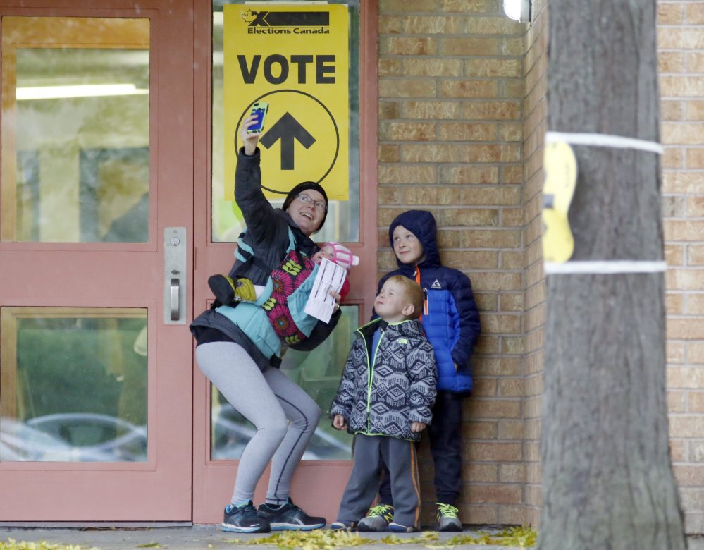 Alexandra Pettit takes a selfie with her kids at the Gloucester Presbyterian Church polling station in Ottawa, after casting her vote in the Canadian federal election on Monday.