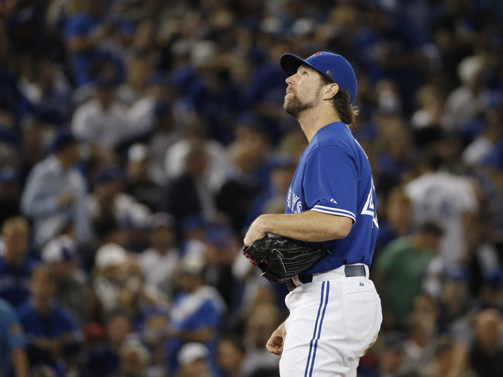 Blue Jays starting pitcher R.A. Dickey appears to be looking for answers after being relieved in the second inning. Dickey gave up five runs and got just five batters out.