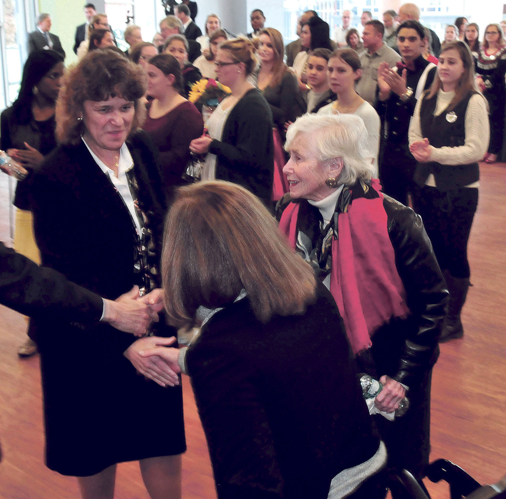Thomas College President Laurie Lachance, left, shakes hands Tuesday with Margie Lunder Goldy, center, and Paula Lunder at Thomas College during a news conference announcing the Center for Innovation in Education. The Lunder Foundation contributed money toward the center in Waterville.