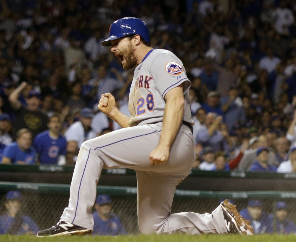 Murphy celebrates after scoring from third base in the seventh inning on a ball hit by Lucas Duda. The Mets took a 5-2 lead in the inning and the Cubs never got any closer.