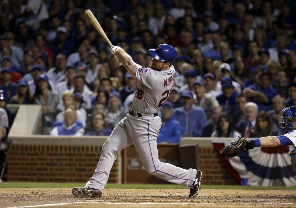 The Mets’ Daniel Murphy hits a home run in the third inning Tuesday night in Game 3 of the National League Championship Series. The Mets took a 2-1 lead and Murphy tied a record by hitting a home run in his fifth straight playoff game.