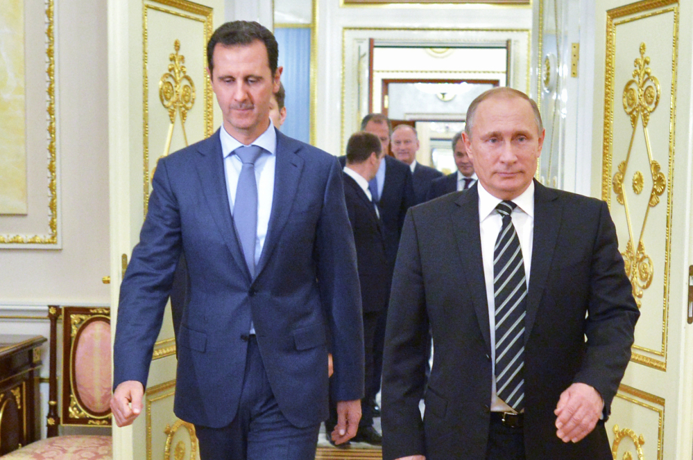 Russian President Vladimir Putin, right, and Syrian President Bashar Assad arrive for a meeting Wednesday.