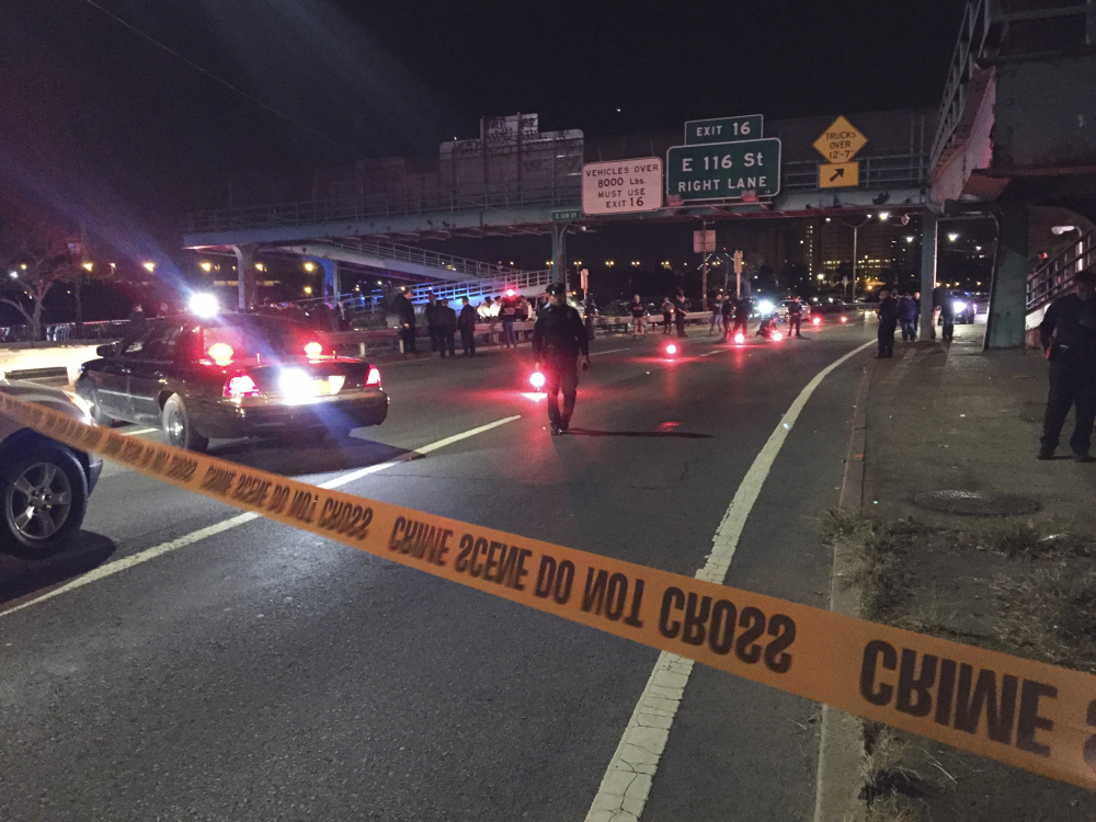 Police officers investigate along FDR Drive at East 120 Street on Tuesday in New York where a New York City police officer was fatally shot.