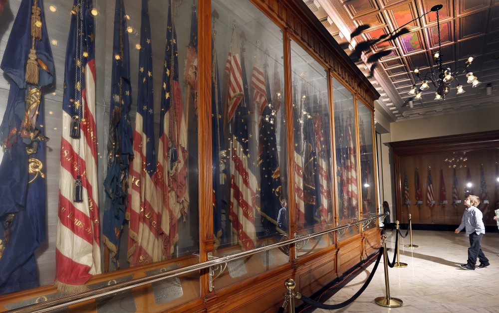 A fourth-grader visits the Hall of Flags in New Hampshire’s Statehouse in Concord. The flags, many of them dating from the Civil War, are deteriorating because their glass cases are not air-tight. The display has made the New Hampshire Preservation Alliance’s “Seven to Save” list this year.