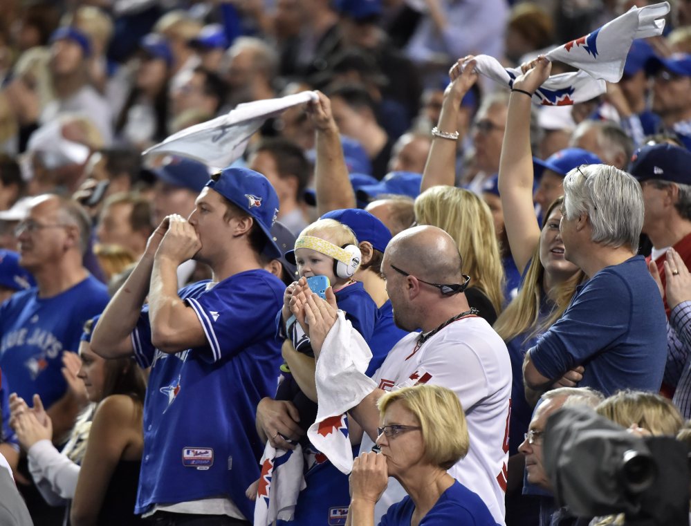 Blue Jays fans cheer, with their team on its way to a 7-1 win and Game 6 of the American League Championship Series on Friday in Kansas City.