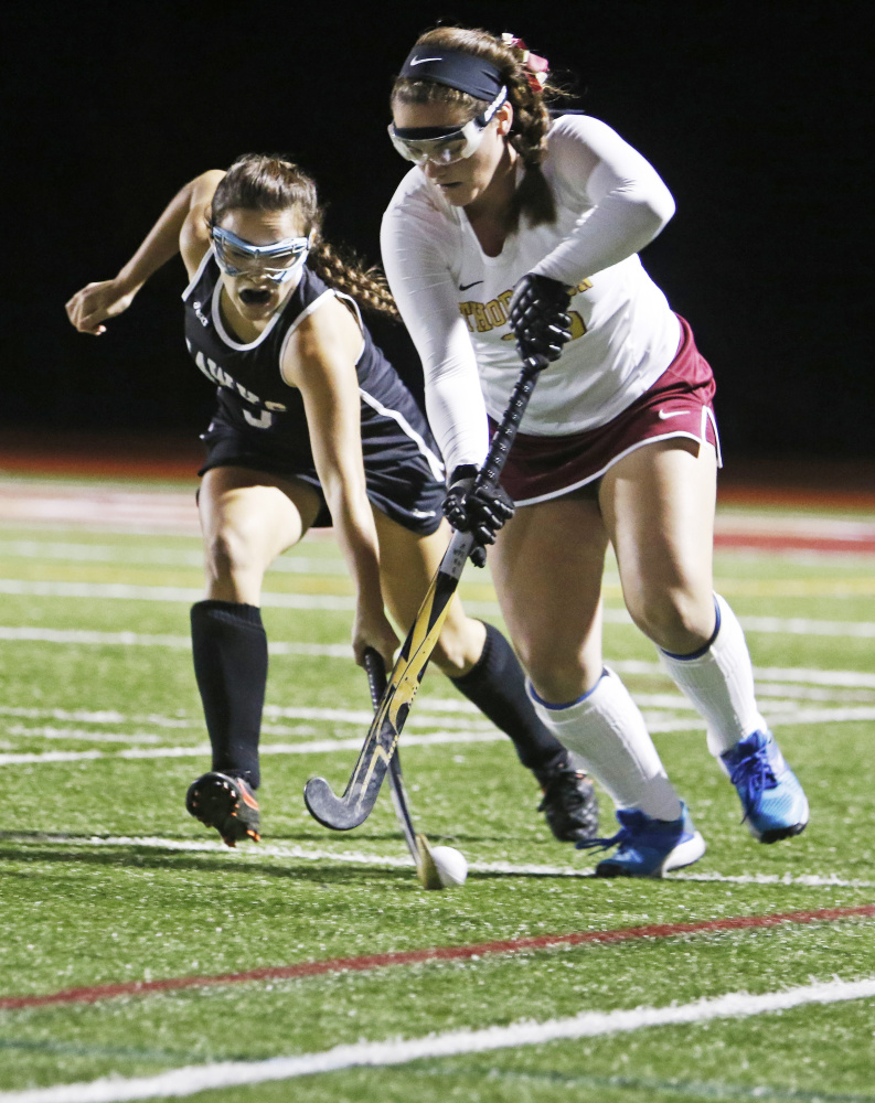 Andrea Longtin of Marshwood attempts to knock the ball away from Emma Dutremble of Thornton Academy in the first half Wednesday night. Thornton scored two second-half goals to win the Class A South field hockey quarterfinal, 2-1.