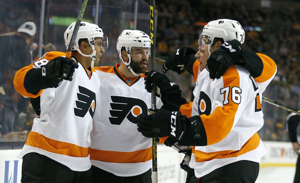 The Flyers’ Pierre-Edouard Bellemare (78) celebrates his goal with teammates Radko Gudas (3) and Chris VandeVelde (76) in the first period.
