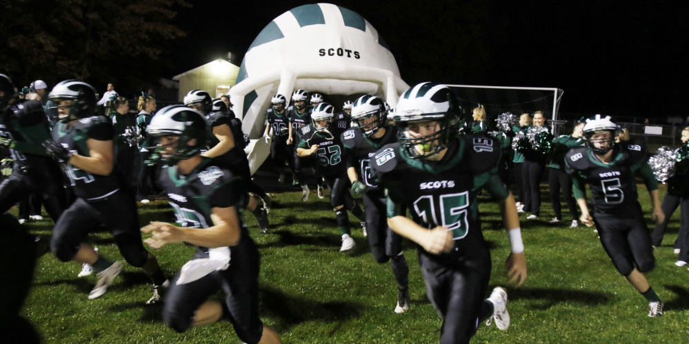 A helmet-shaped tunnel provided by the football boosters club at Bonny Eagle gives young players  a sense of what it’s like to be in the big time.