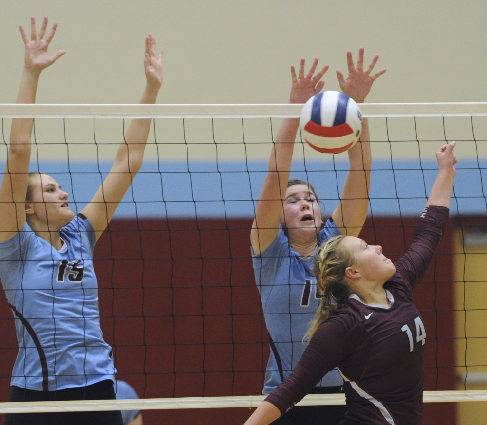 Nataley Jeffrey, left, and Jamie Jannarone of Windham attempt to block a hit by Cassidy Landry of Gorham.