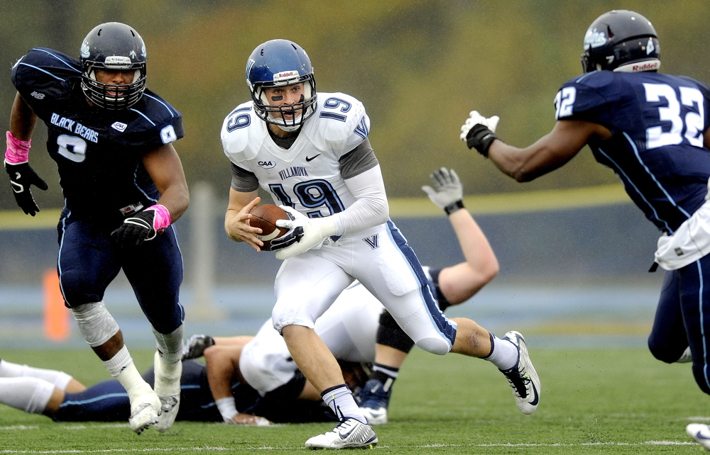 Maine’s Trevor Bates, left, has sent a lot of quarterbacks scurrying the last two seasons, including Villanova’s John Robertson. Bates is being eyed by pro scouts. 2014 Press Herald File Photo/Gabe Souza