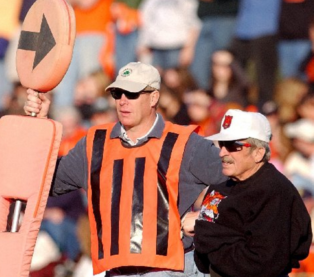 Sonnie Gamache, right, stands on the sideline of a Gardiner Area High School football game in 2005. Gamache has measured first downs for 11 coaches.