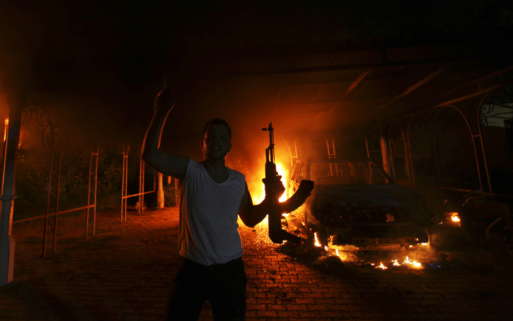 A gunman reacts as the U.S. Consulate in Benghazi, Libya, burns on Sept. 11, 2012, after an attack by an armed group. U.S. Ambassador Christopher Stevens and three other U.S. nationals died in the attack. Organized terror groups were later identified as the attackers.