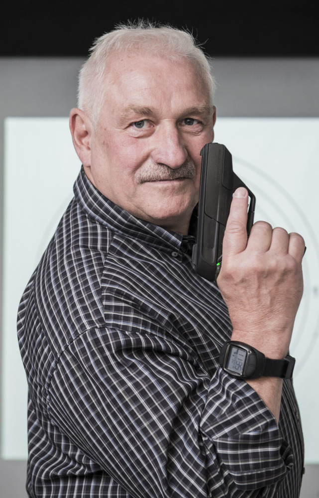 Gun designer Ernst Mauch poses with the Armatix iP1 he designed. He is in the U.S. this week, looking into starting a new company to make smart guns that police can use.