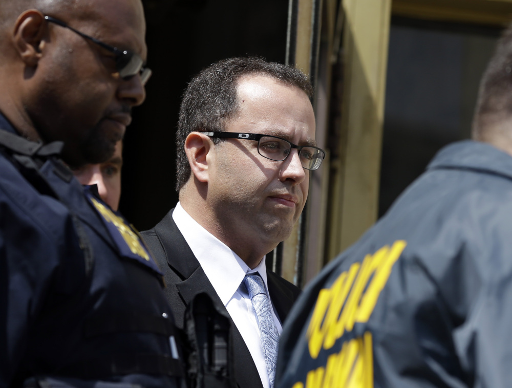 Former Subway restaurant spokesman Jared Fogle leaves court in Indianapolis on Aug. 19 after a hearing. Fogle agreed to plead guilty to child pornography and sex-with-minors charges.