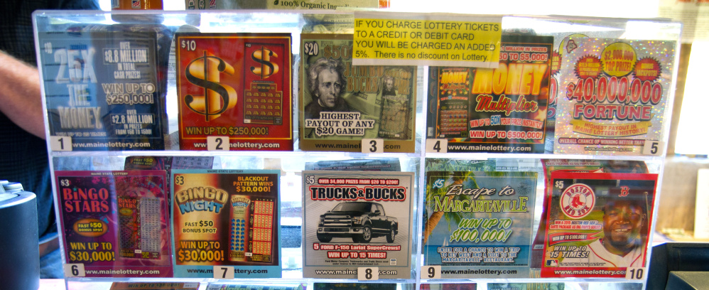 The flashy designs and “carnival barking” of these scratch tickets – on display at the Waite General Store in Washington County – are intended to catch the eye and spur impulse buys.