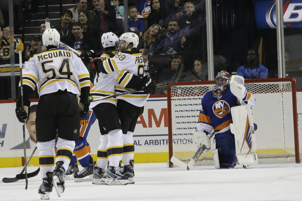 Bruins left wing David Pastrnak (88) celebrates with teammates after scoring the tie-breaking goal in the second period of Boston’s win Friday night in New York.
