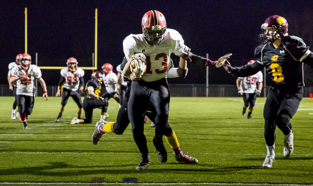 Wells junior Deandre Woods scores the second touchdown of the night Friday during a shutout at Cape Elizabeth. Ben McCanna/Staff Photographer