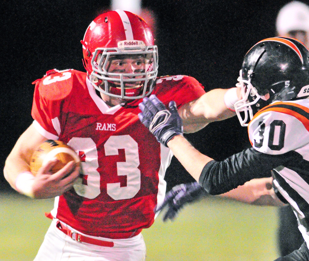 Reid Shostak of Cony keeps Isaiah Swan of Gardiner away Friday night during Cony’s 40-0 victory at Augusta.