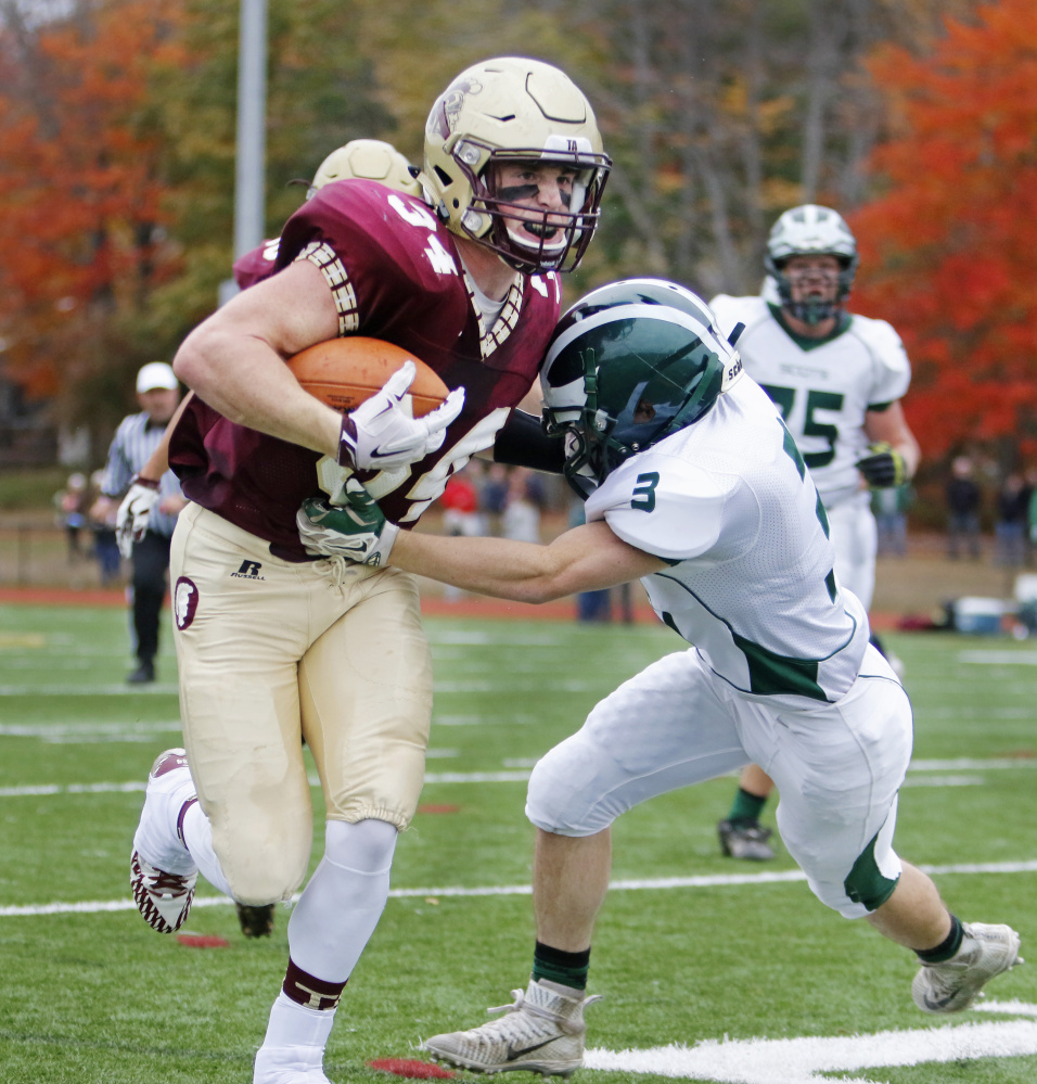 Bonny Eagle’s Zac Ryan tries to stop Thornton Academy’s Owen Elliott, who went on to score a touchdown in the first half at Thornton Academy on Saturday. Jill Brady/Staff Photographer