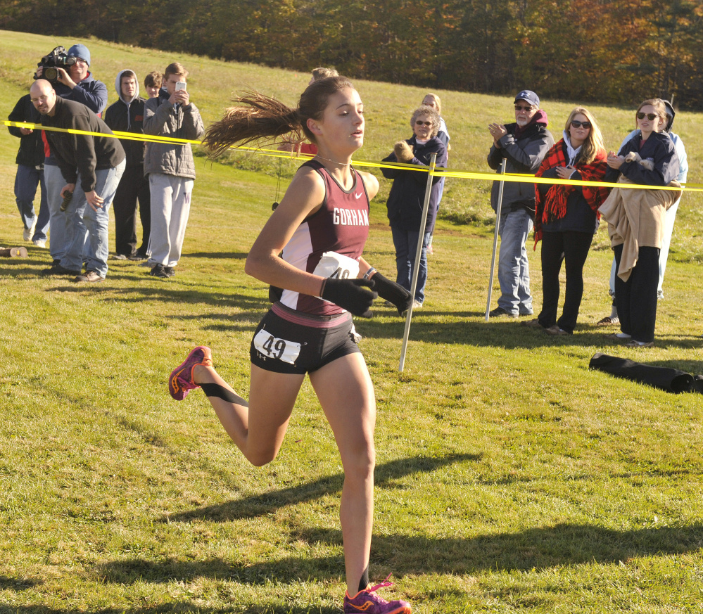 Anna Slager of Gorham crosses the finish line to win the Class A South girls’ race Saturday at the regional cross country championships, held at Twin Brook Recreation Area in Cumberland.