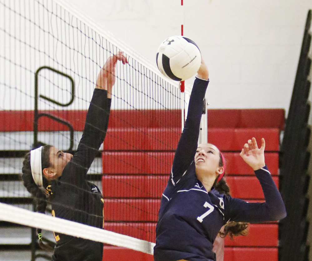 Yarmouth’s Liz Clark just misses the volleyball with Cape Elizabeth’s Monika Scheindel at the net in a quarterfinal game at Cape Elizabeth on Saturday. Jill Brady/Staff Photographer