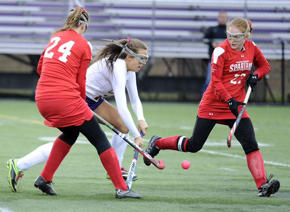 Carrie Hight of Cheverus races up the field with the ball between Sanford defenders Annie Ledue, left, and Allison L’Heureux in Saturday’s Class A South semifinal.