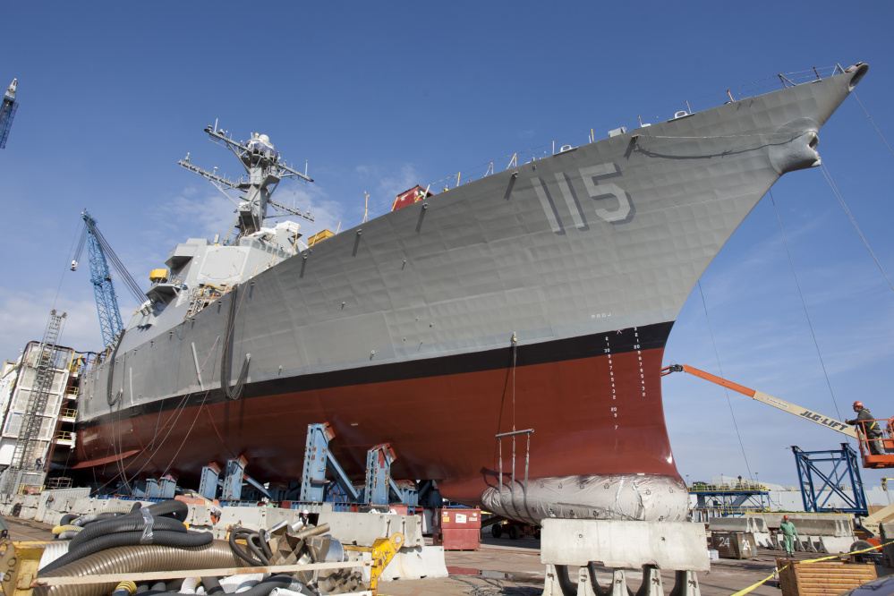 The USS Rafael Peralta sits at Bath Iron Works, ready to have the mother of its namesake Marine war hero christen the warship by breaking a bottle of champagne across its bow on Saturday. Peralta died 11 years ago in Iraq.