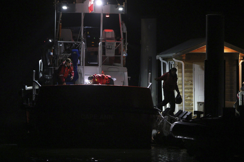 Canadian Coast Guard crew arrive at a dock in Tofino, on the west coast of Vancouver, Canada, early Monday following a search and rescue operation for people who were on board a whale-watching boat when it sank off Vancouver Island on Sunday, Canadian authorities said.