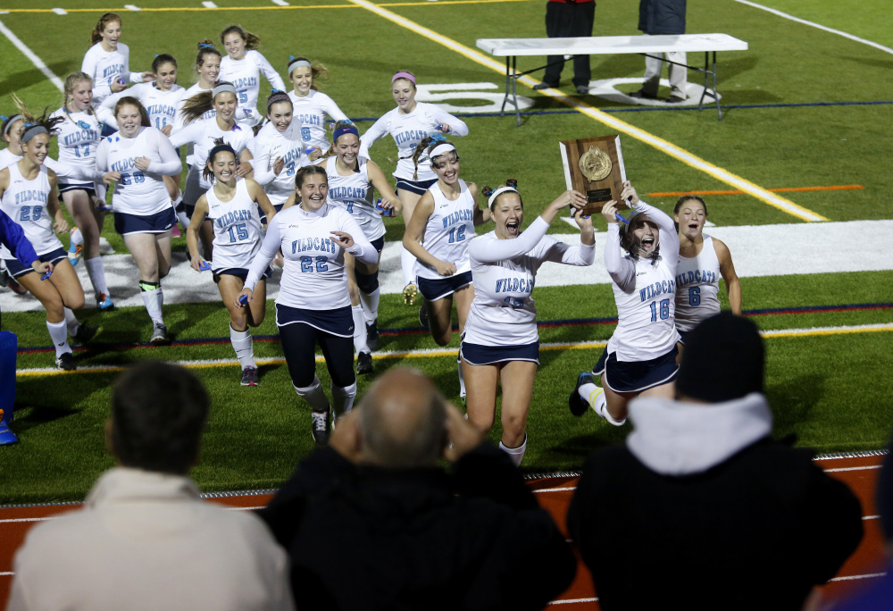 Catherine Marcoulier, left, and Devon Datsis celebrate with their teammates after York beat Leavitt 3-1 in the Class B South field hockey championship game Tuesday at Fitzpatrick Stadium in Portland.