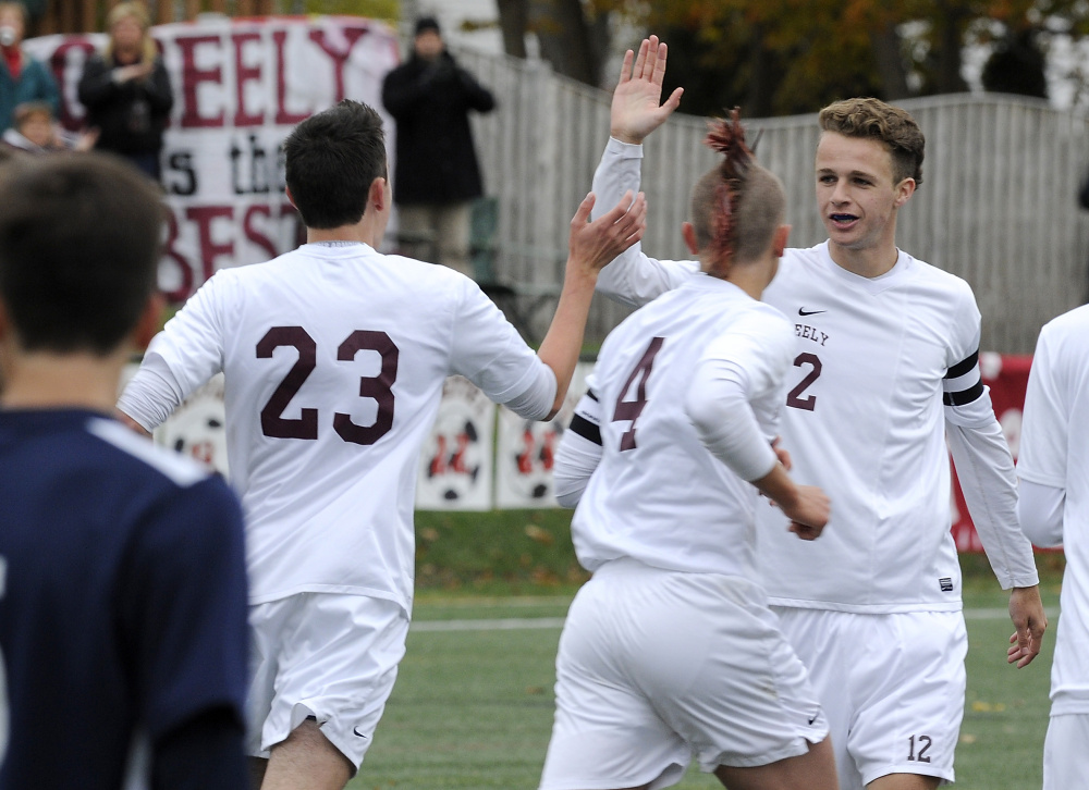 Greely’s Jacob Nason gives a high-five to teammate Nick Pronovost, 23, after the first goal of the game Wednesday at North Yarmouth Academy. Greely defeated York, 3-2, in a Class B South boys’s soccer quarterfinal. Gordon Chibroski/Staff Photographer