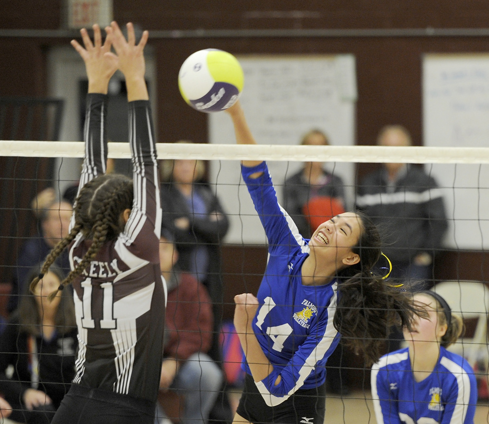 Alison Noyes of Falmouth slams the ball past Molly Chapin of Greely during their Class A volleyball semifinal Wednesday night. Greely won in five sets and will meet Scarborough for the state title Saturday.