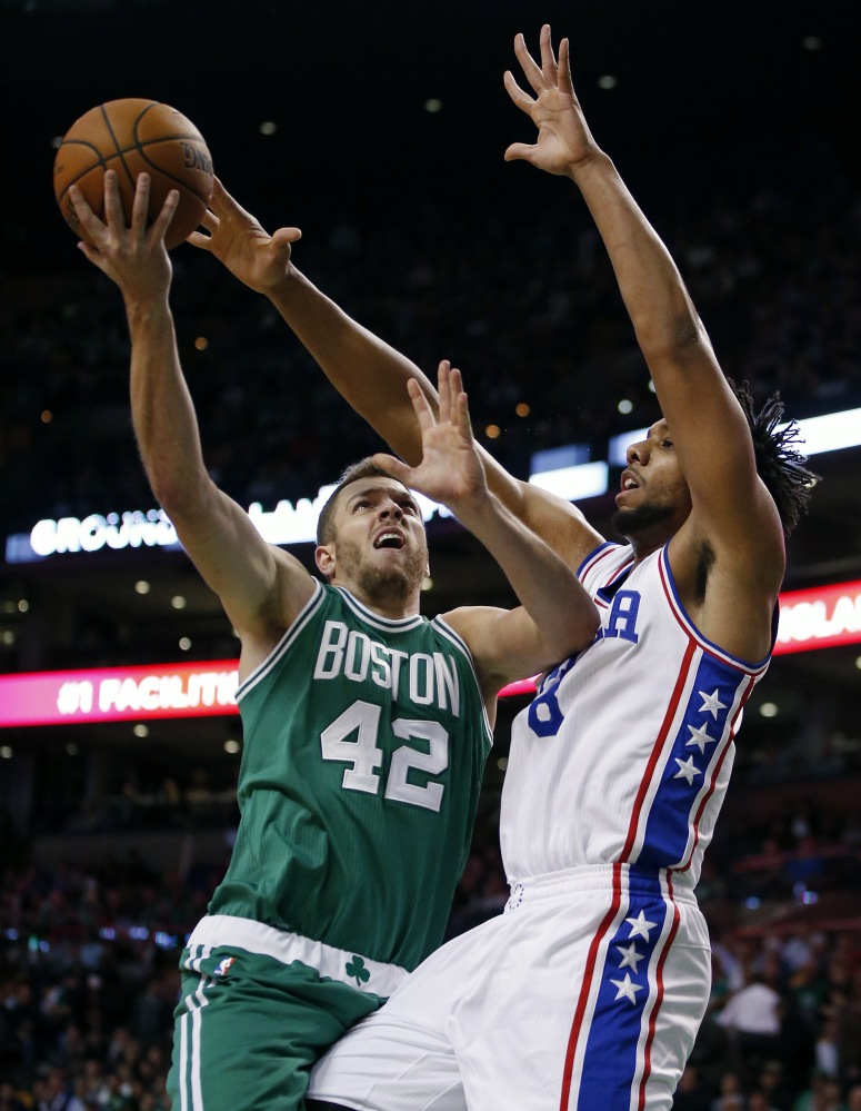 Philadelphia’s Jahlil Okafor blocks a shot by the Celtics’ David Lee in the first quarter. Okafor led the 76ers with 26 points in the game.