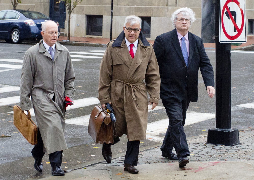 Dr. Joel Sabean of Falmouth, right, walks into U.S. District Court in Portland in October 2015 to face a 58-count indictment, with his attorneys Jay McCloskey and Thimi Mina. On Monday, Sabean's accountant and bookkeeper testified in his trial that they warned the doctor that if he kept sending money to a family member, he would bankrupt his medical practice.
