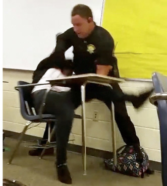 This three-image collage made from video taken by a Spring Valley High School student Monday shows Senior Deputy Ben Fields trying to forcibly remove a student from her chair after she refused to leave her high school math class, in Columbia, S.C. The Justice Department opened a civil rights investigation Tuesday after Fields flipped the student backward in her desk and tossed her across the floor.