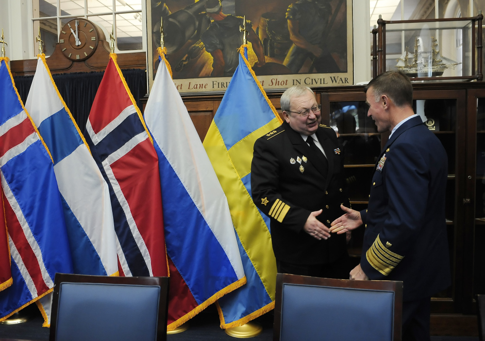 Adm. Paul Zukunft, the U.S. Coast Guard commandant, right, shakes hands with Adm. Yuri Alekseyev of the Russian Federation as they gather with coast guard leaders from Arctic nations to pledge cooperation in northern seas, on Friday in New London, Conn.