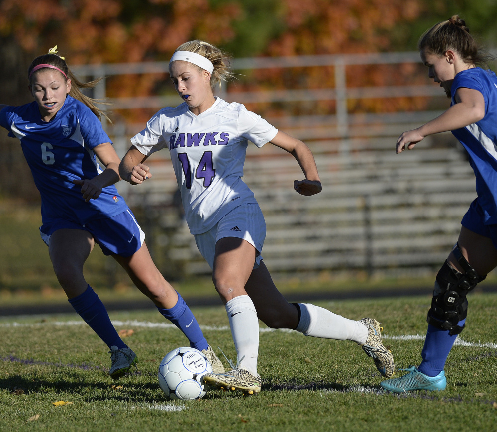 Marin Smith of Marshwood pushes forward between Kennebunk’s Kendall Dolan, left, and Kelli Molloy during their Class A South semifinal Friday. Smith scored three goals in a 4-1 win.