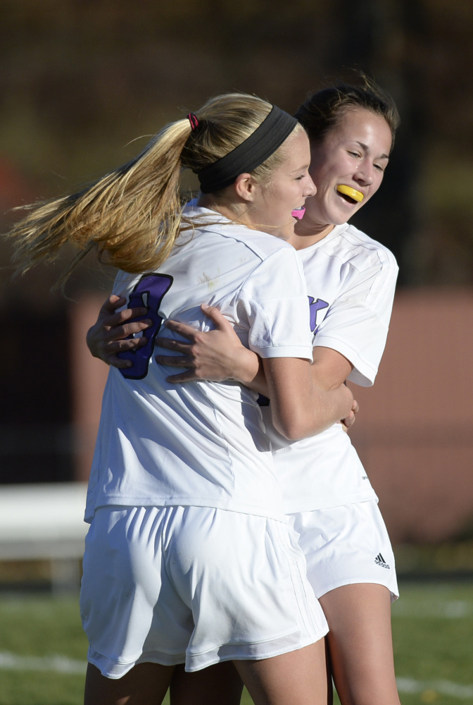 SOUTH BERWICK, ME - OCTOBER 30: Marshwood's Reagan Nichols, left, congratulates Molly Ferguson after Ferguson scored a first half goal against Kennebunk in girls soccer Friday, October 30, 2015. (Photo by Shawn Patrick Ouellette/Staff Photographer)