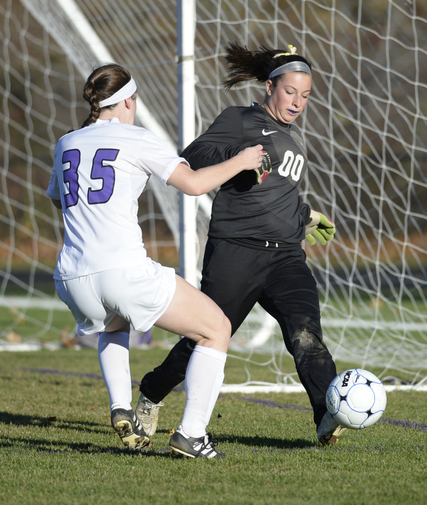 SOUTH BERWICK, ME - OCTOBER 30: Kennebunk goalie Kyra Schwartzman reaches the ball before Marshwood's Hannah Fife in girls soccer Friday, October 30, 2015. (Photo by Shawn Patrick Ouellette/Staff Photographer)