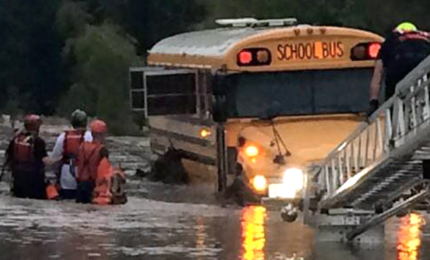 Emergency personnel rescue four special-needs students and two adults from a school bus caught in floodwaters near San Antonio, Texas, on Friday.