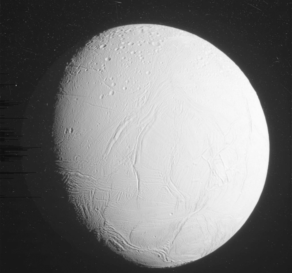 Above, Enceladus floats in space above Saturn’s rings in this photo provided by NASA on Friday. Far left, a NASA image show’s the moon’s icy surface. An earlier photo shows plumes of what is believed to be water shooting from below the surface.