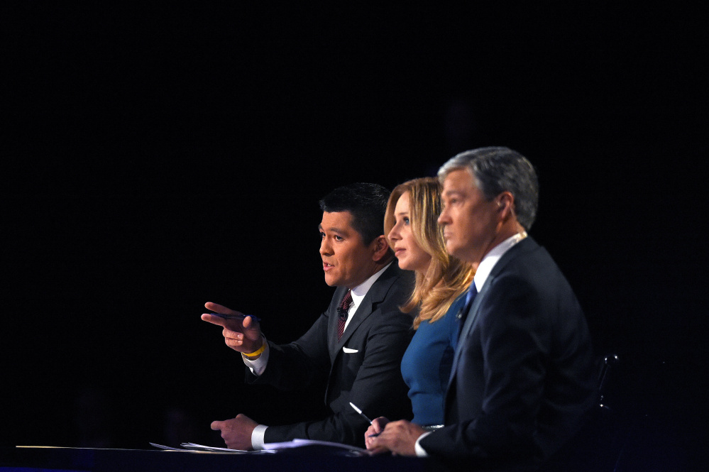 Debate moderators Carl Quintanilla, left, Becky Quick, center, and John Harwood appear during the CNBC Republican presidential debate at the University of Colorado, Wednesday, Oct. 28, 2015, in Boulder, Colo. (AP Photo/Mark J. Terrill)
